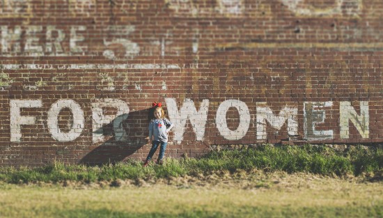 Girl in front of mural