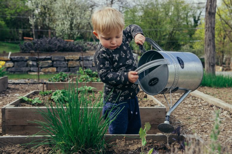 baby watering plants